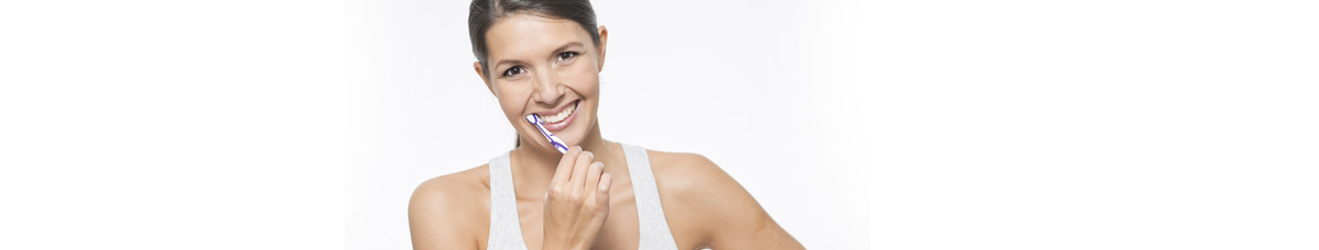  - woman brushing her teeth